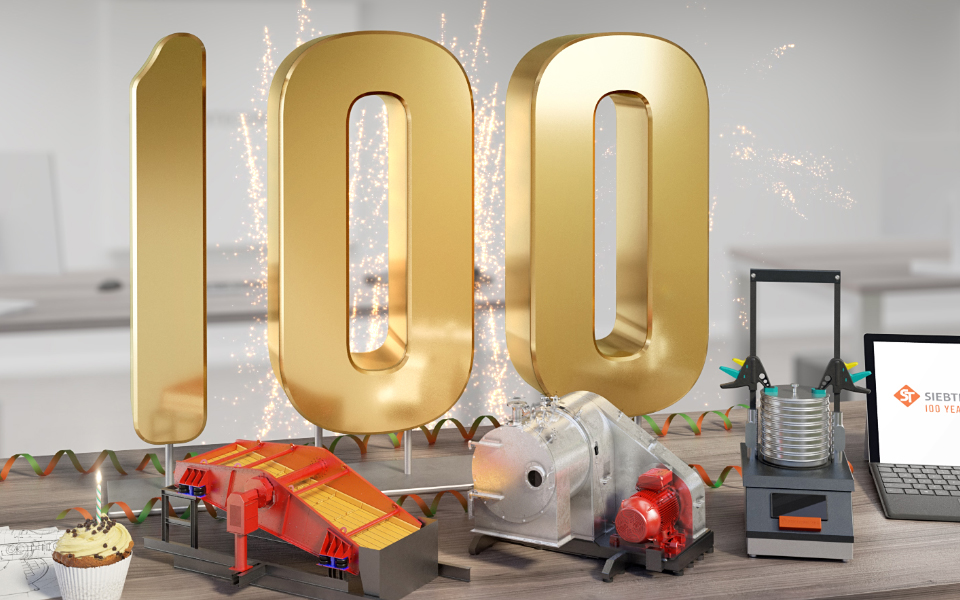 SIEBTECHNIK TEMA wird 100 Jahre - Büroszene mit großer goldener 100, einem Feuerwerk, einem Törtchen mit Kerze, und einigen Beispielprodukten (Siebmaschine, Zentrifuge, Analysensiebmaschine)